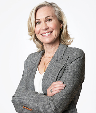 Jennifer Keesmaat standing with arms crossed and smiling. 