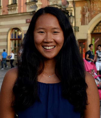 Kayla smiling in front of a building.