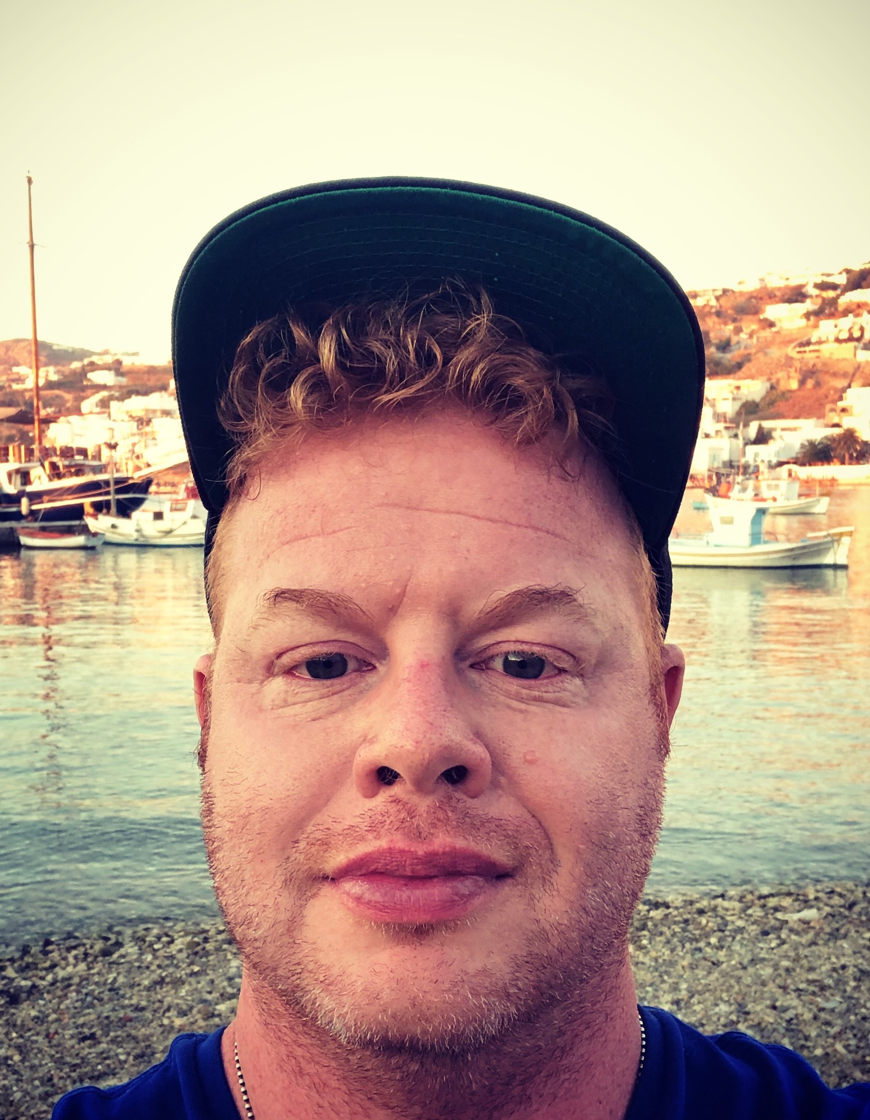 David smiling in front of a beach.